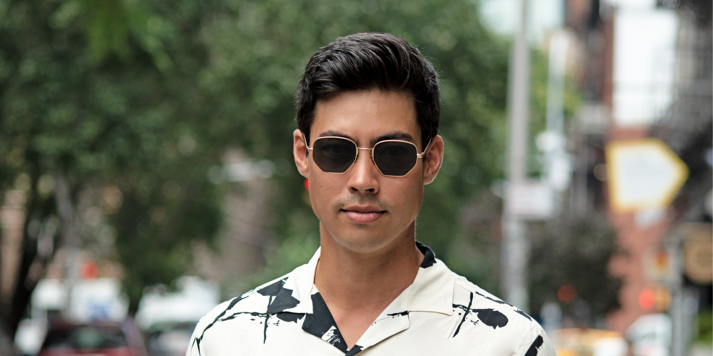 Man wearing polarized Vint & York sunglasses outdoors, showcasing glare-reducing lenses and vintage-inspired frames.